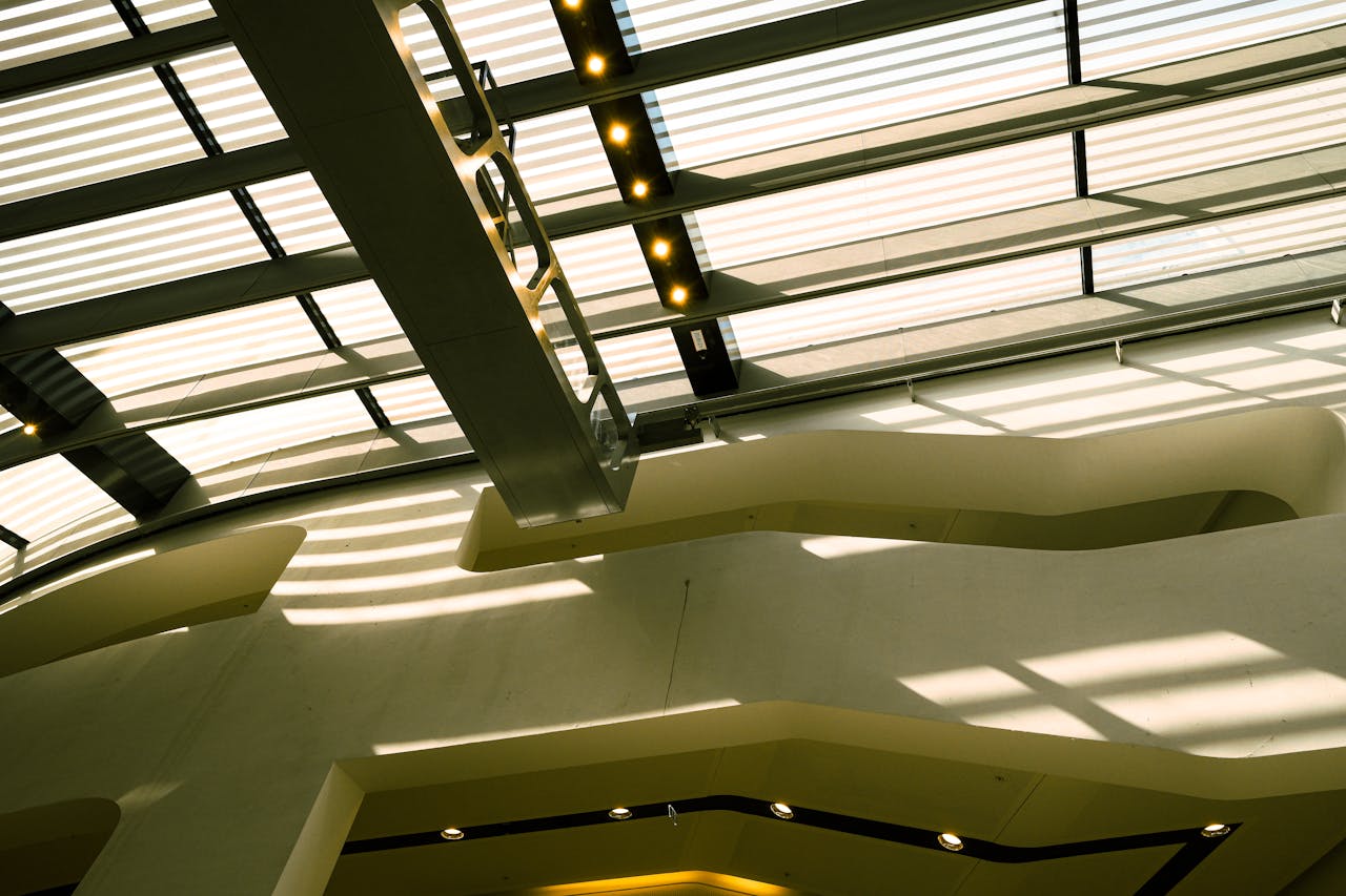 about-02 A contemporary ceiling design casting geometric shadows, showcasing modern architecture.