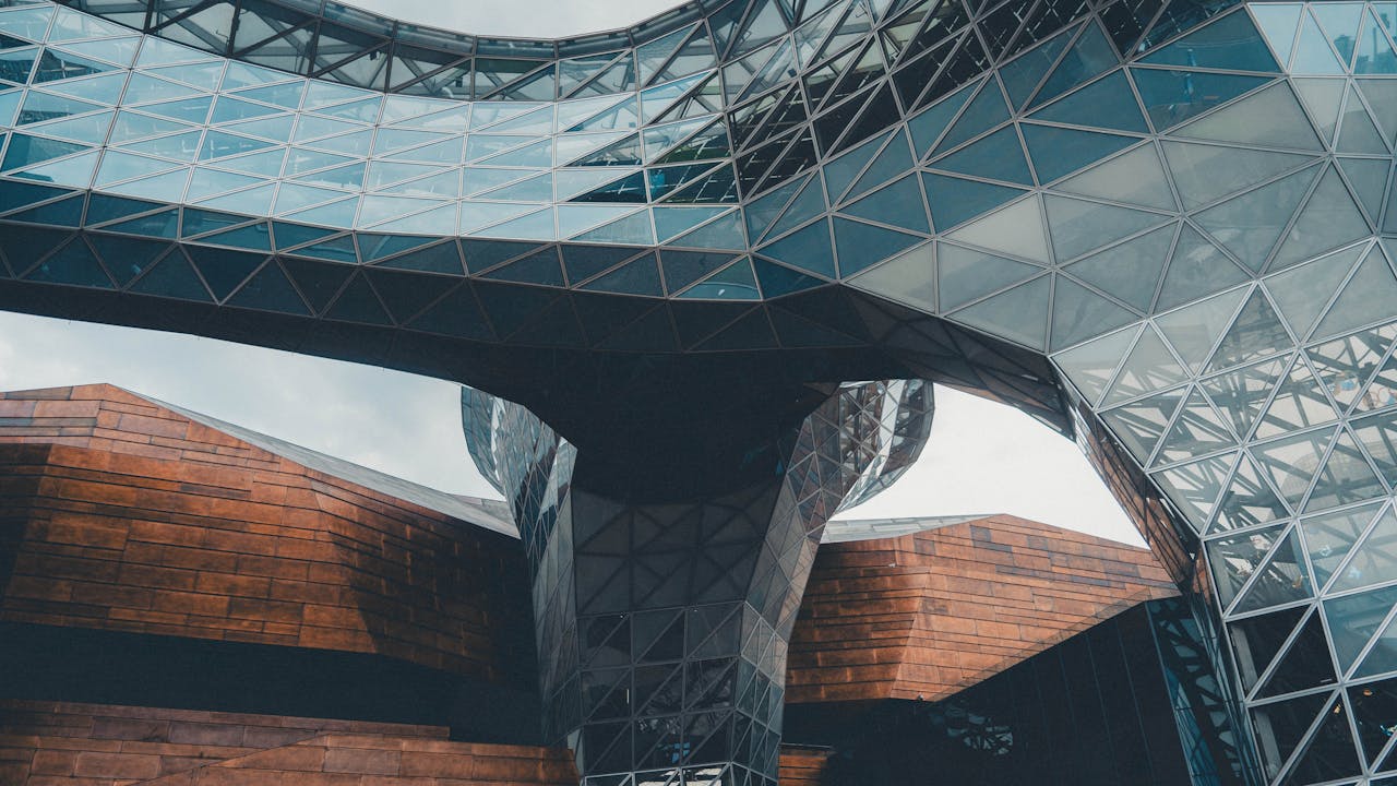 our-experience Dynamic view of a modern architectural structure featuring glass and steel elements.